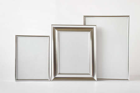 Mockup template with set of three silver glossy metallic frames with blank space on white background.の写真素材