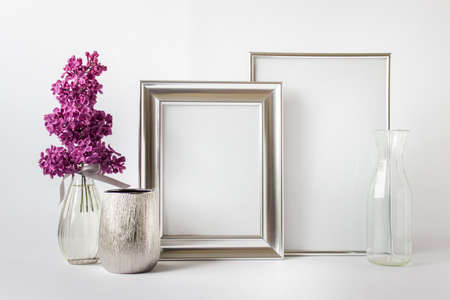 Mockup template composition with two silver frames, glass vases and pink lilac flowers.の写真素材