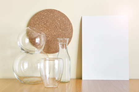 Mockup template composition with glass vases, round cork decor and A4 paper sheet for kitchen recipe...
