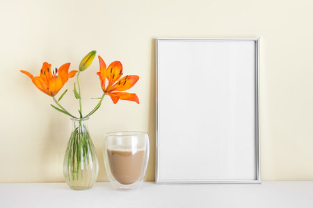 A4 blank silver frame with blank empty space surface, orange lily, morning coffee.の写真素材