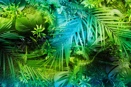 Tropical pattern with many randomly arranged synthetic leaves.