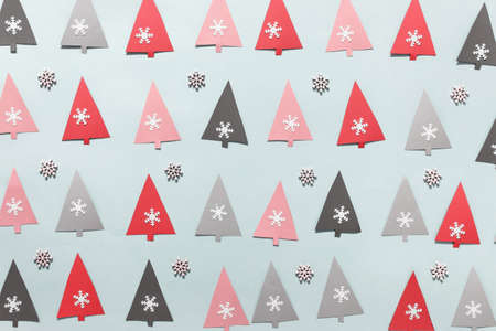 Christmas, New Year greeting card with paper pattern with pink, red, black paper Christmas trees and snowflakes.の写真素材