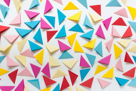 Abstract background with randomly arranged colorful folded triangles on white background.の写真素材