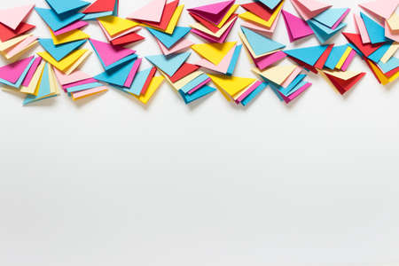 Abstract background with many folded paper triangles at image top and blank space.の写真素材
