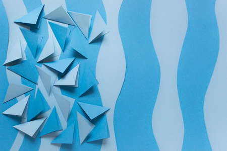 Paper background with many blue folder triangles and blue paper layers.の写真素材