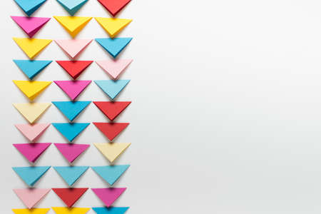 Simple paper background with tree rows of paper folded triangles. Photo with copy blank space.の写真素材