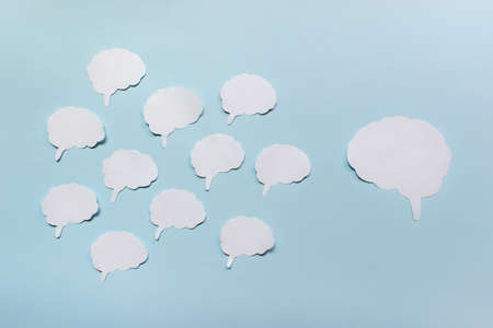 Psychological communication concept with many small brains and one large brain on blue background.の写真素材