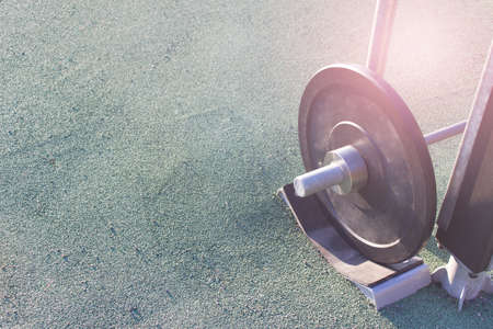 Outside sport, workout gear - heavy weights on green artificial grass surface. Image with copy blank...