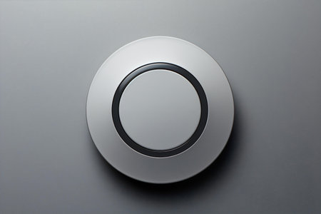 A matte black button featuring a central circle, set on a gray mockup background, Generative AIの素材