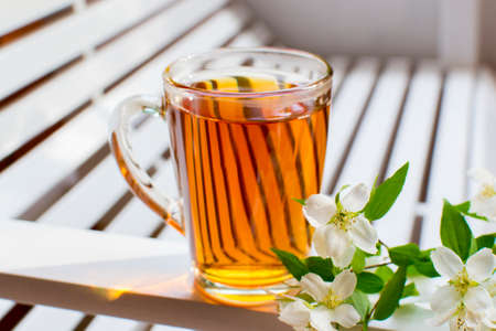 Herbal tea with flowers on rustic wooden table. Summer tea menu.の写真素材