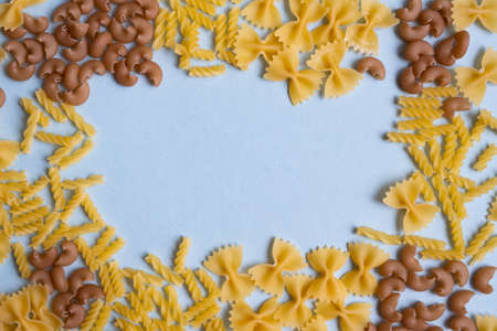 Pasta on a blue surface. FlatLay. Copy space. Top view. Frameの写真素材