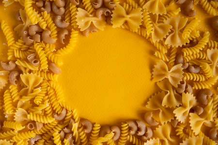Pasta on a yellow surface. FlatLay. Copy space. Top view. Frameの写真素材