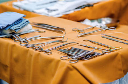 Sterile surgical instruments on the table near the operating table.の写真素材