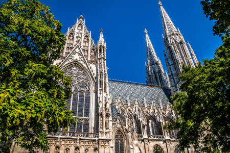 The majestic beautiful church of Votivkirche against the blue sky. Vein. Austriaの写真素材