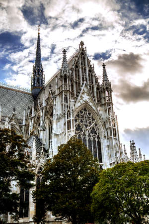 Incredibly beautiful cathedral of Votivkirche against a cloudy sky. Vienna Austriaの写真素材