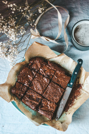 Homemade chocolate brownies on rustic background, top view.