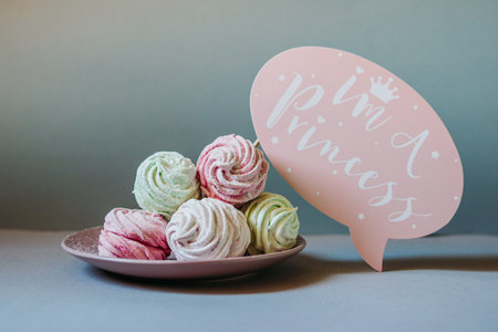Home made zephyr on a neutral grey background with pink paper speech bubble with text im a princessの写真素材
