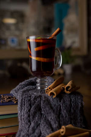 Mulled wine in glass cup with spices. Hot red drink in winter evening. Christmas eve. Seasonal and holidays concept. Selective focusの写真素材