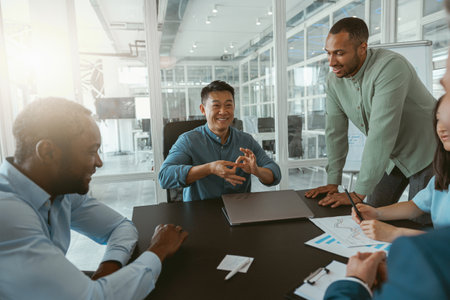 Group of multiethnic business people working together on project while sitting in modern office