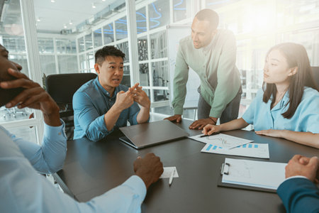 Group of multiethnic business people working together on project while sitting in modern office