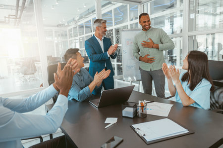Group of multiethnic business people working together on project while sitting in modern office