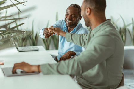 Two african business colleagues working together in modern officeの写真素材