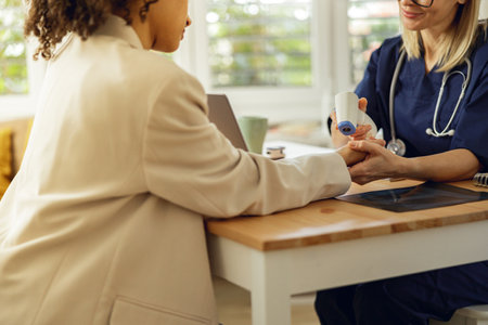 Close up of doctor measures patients temperature with non-contact thermometer in clinicの写真素材