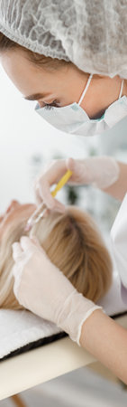 Side view of professional doctor is making mesoterapia injection, hair loss treatmentの写真素材