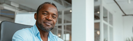 Confident African businessman taking notes while working in modern officeの写真素材