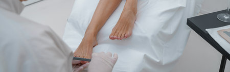 Close up of professional nail master making pedicure for female client in spa saloneの写真素材