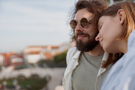 Close up of couple in love hugging and smiling on city street during summer vacationの写真素材