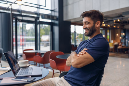 Smiling businessman have a business meeting via video call sitting in cafe. Distance work conceptの写真素材