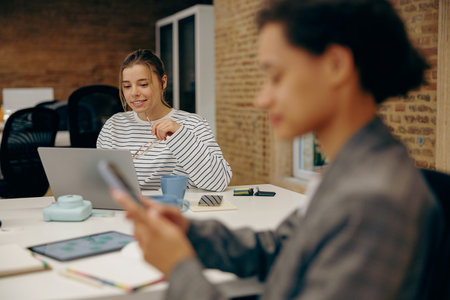 Successful female business people working together in a coworking officeの写真素材