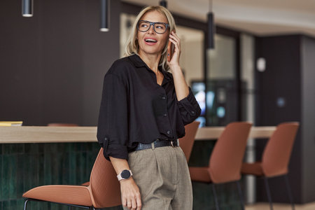 A Stylish and Professional Woman Fully Engaged and Active in a Modern Office Environmentの写真素材