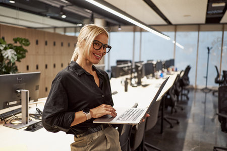 A Professional Woman Working in a Modern Office Environment Using Her Laptop Effectivelyの写真素材