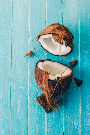 Chopped coconut on a blue wooden background