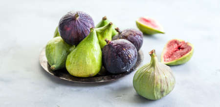 Figs, green and blue, gray stone backgroundの写真素材
