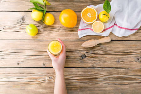Citrus juice. Lemons and oranges on wooden backgroundの写真素材