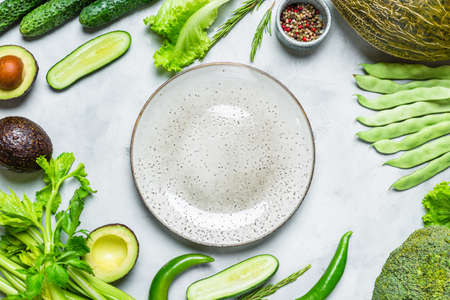 Food frame. Fresh green vegetables and a plate. Copy spaceの写真素材