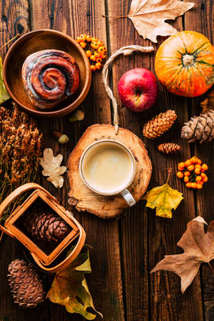 Delicious cappuccino with a bun on an autumn background. Home comfortの写真素材