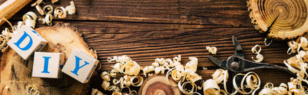Wood saw cut, shavings and carpentry tools. DIY from wood. Long banner. Copy space