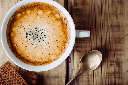 Delicious hot cappuccino on wooden tableの写真素材