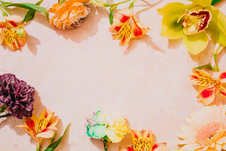 Fresh flowers frame on pink background