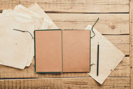Vintage paper. Old notepad on a wooden background. Copy spaceの写真素材