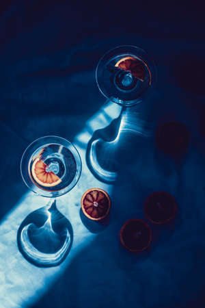 Minimal still life with oranges. Hard shadows. Blue tinted.の写真素材