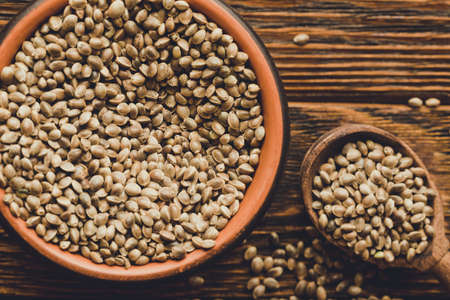 Hemp seed in clay bowl on wooden backgroundの写真素材