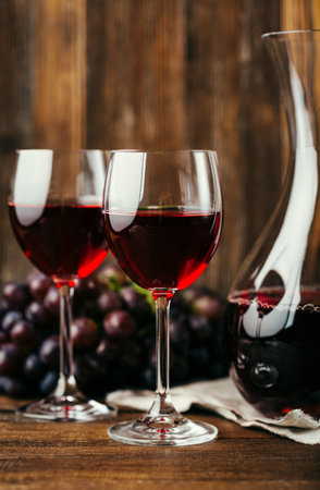 Two glasses of red wine on a wooden background. Selective focus.の写真素材