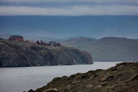A small village on a rocky cliff above the waterの写真素材