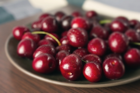 Group of fresh cherries on a plateの写真素材