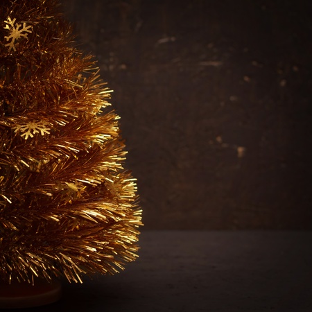 Golden christmas tree wiht dark wooden backgroundの写真素材